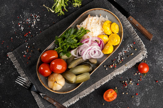 Assorted vegetable pickles on a plate. Tomatoes, squash, cucumbers, onions, cabbage