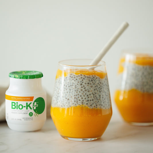 Bio-K+ bottle (mango flavored) with pudding in a glass