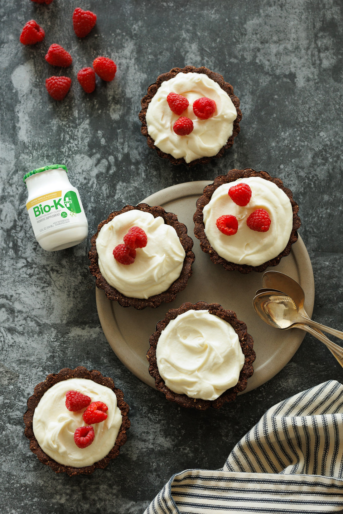 Mini tartlets in a plate with a Bio-K+ bottle