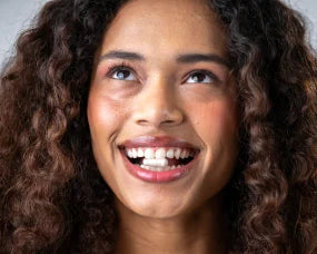 Woman taking a probiotic capsule to support gut health and anxiety relief.