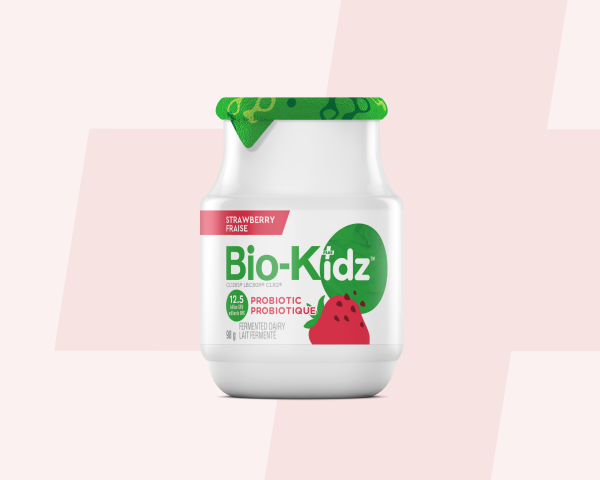 Boy with a bottle of Bio-kidz playing with his cars.